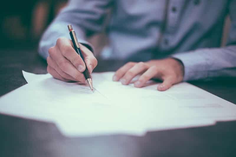 real estate term of a man signing a contract