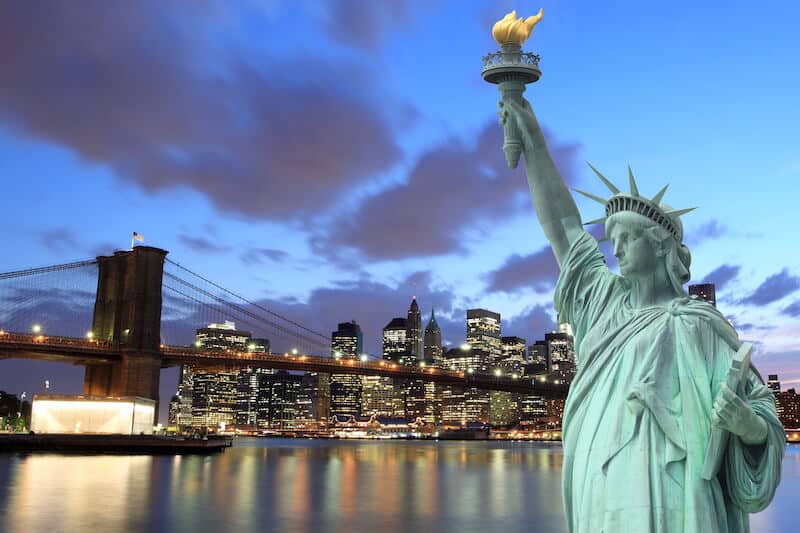 New York City at night - Brooklyn Bridge and Statue of Liberty